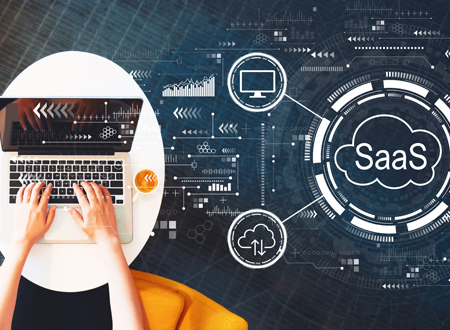 Laptop on right SaaS diagram on left - SaaS Explained - Technology Talk Featured-Image