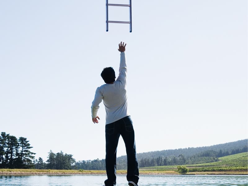 man-reaching-ladder-websites Man reaching for a ladder - websites