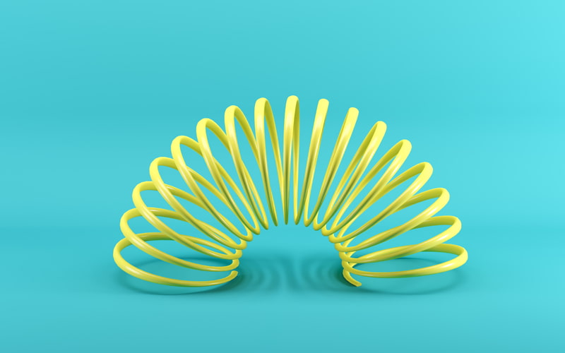 Yellow slinky on blue turquoise background