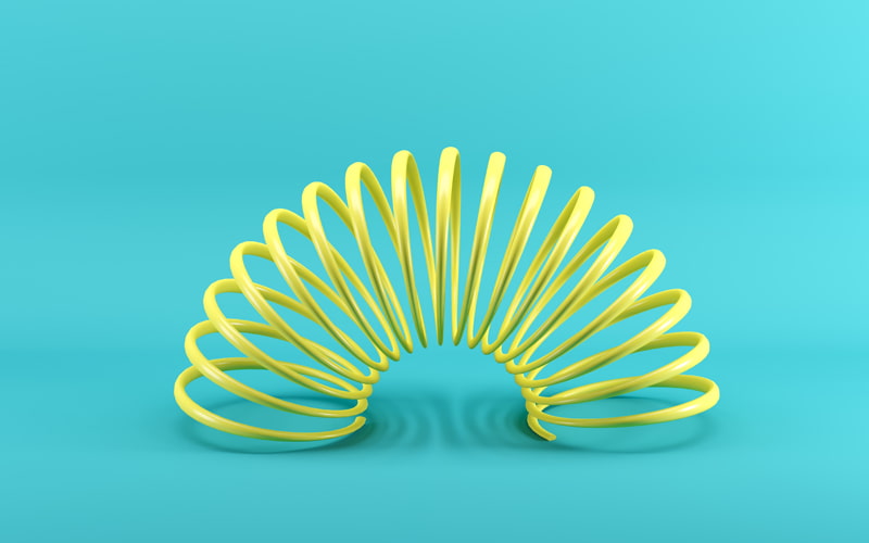 slinky-ihp Yellow slinky on blue turquoise background